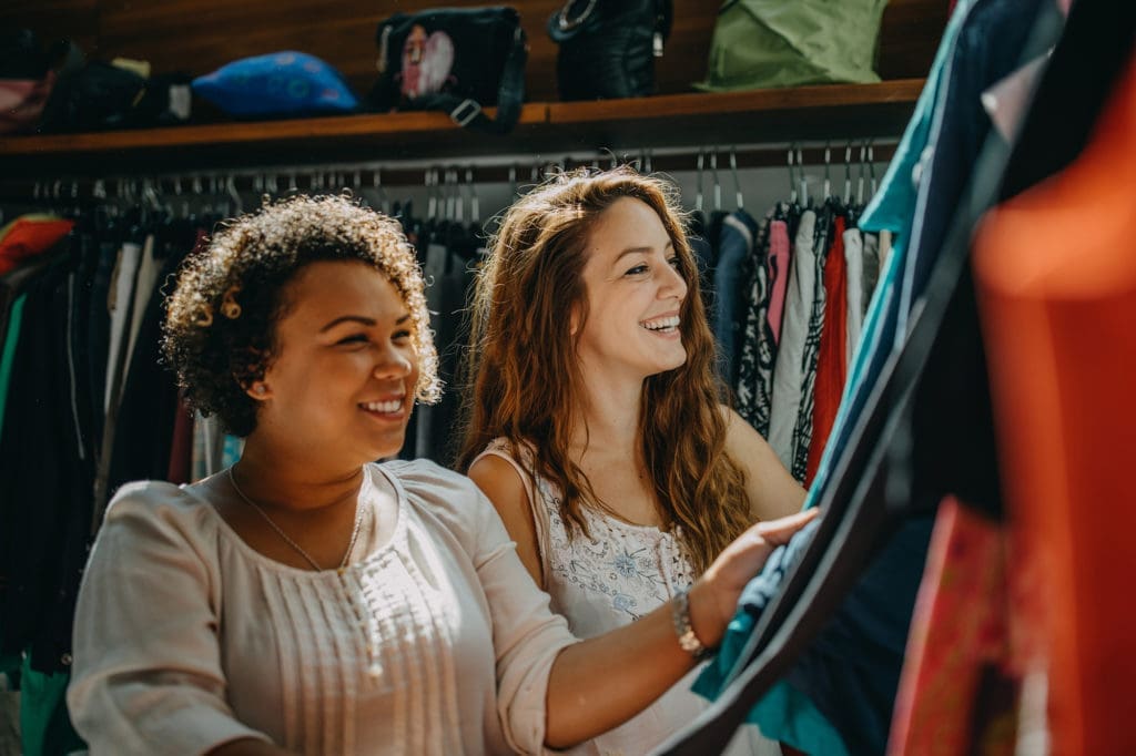 Young women vintage clothes shopping